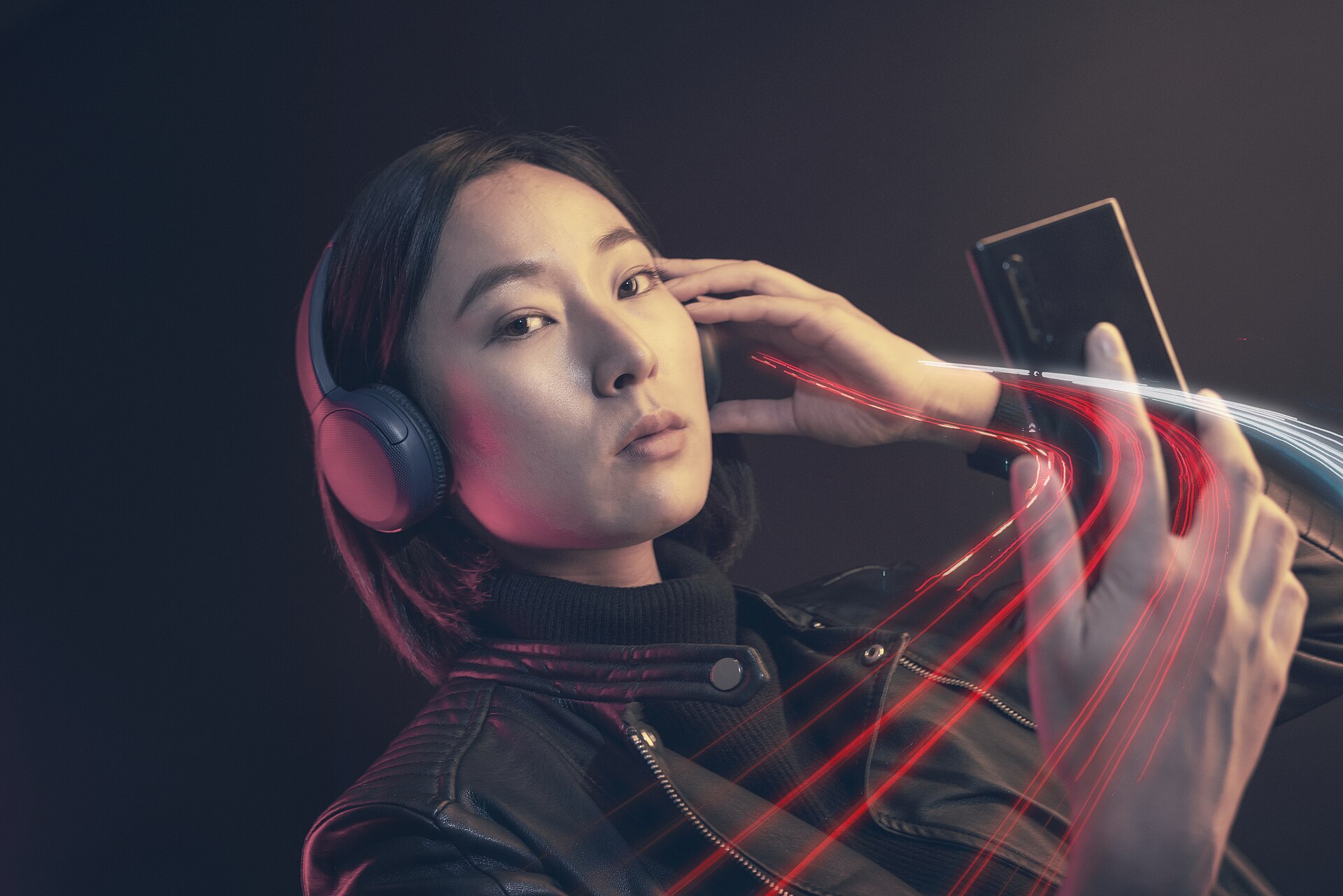 Person listening to music on a smartphone with wired headphones
